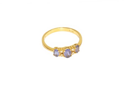 Lot 60 - A Tanzanite and Diamond Ring, three graduated...