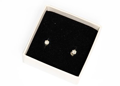 Lot 90 - A Pair of Diamond Solitaire Earrings, the...