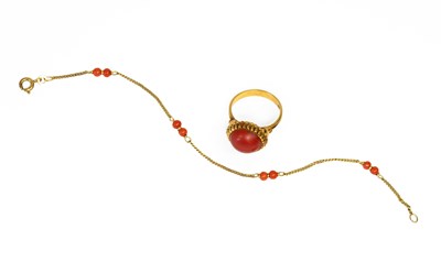 Lot 27 - A Coral Ring, the round cabochon in a yellow...
