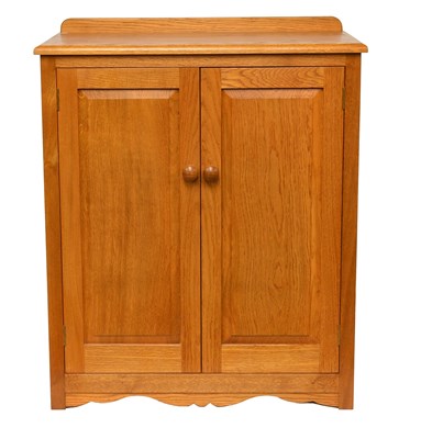 Lot 525 - A Modern Oak Two Door Cabinet, the moulded...