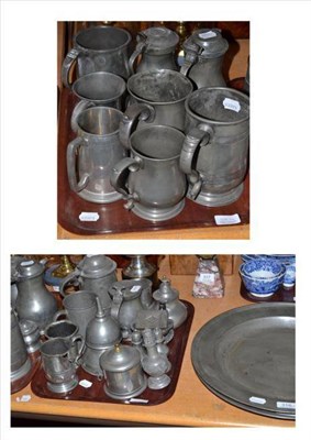 Lot 316 - Two pewter chargers and two trays of pewter including measures, tankards, funnels etc