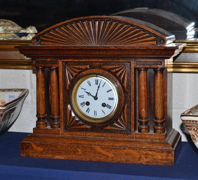 Lot 387 - An oak mantel clock and key