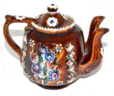 Lot 56 - A Measham Bargeware Teapot and Cover, dated 1883, of ovoid form with twin spouts, applied with...