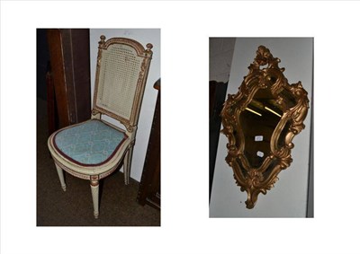 Lot 471 - A white painted salon bergere chair and a gilt framed mirror