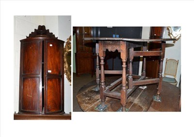 Lot 473 - 19th century mahogany bow fronted hanging corner cupboard and an oak drop leaf table