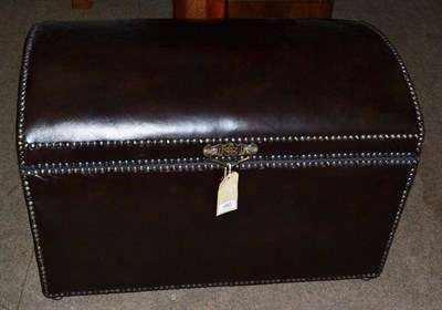 Lot 482 - A leather dome-top trunk