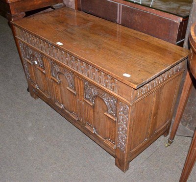 Lot 515 - A reproduction carved oak blanket box