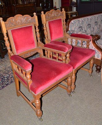 Lot 522 - A pair of carved oak open armchairs with red velvet upholstery