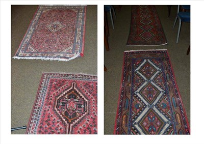 Lot 531 - A narrow Hamadan runner Persian Kurdistan, the field with a column of polychrome stepped medallions