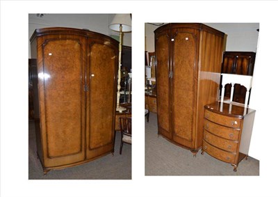 Lot 561 - A Butilux walnut four piece bedroom suite, comprising: two wardrobes, dressing table and chest...