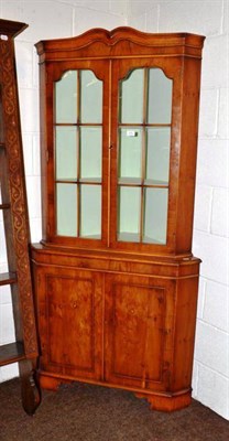 Lot 570 - A yew glazed corner cupboard