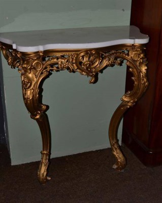 Lot 574 - A marble topped gilt console table