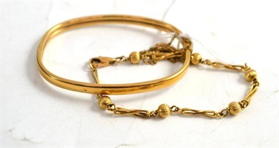 Lot 14 - A 9ct gold bangle, a fancy bracelet and a rope twist bracelet