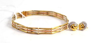 Lot 39 - A 9ct three colour gold gate bangle and a pair of two colour earrings