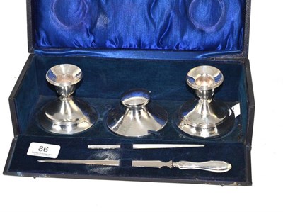 Lot 86 - A silver cased desk set: inkwell, two candlesticks, letter opener and pen