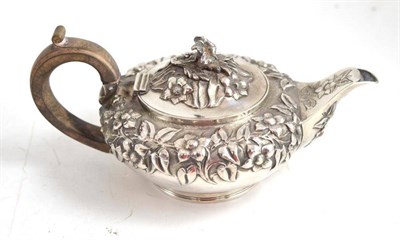 Lot 101 - A William IV silver bachelors teapot, London 1831, decorated in relief with flowers