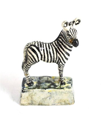 Lot 106 - A Stella Crafts model of a zebra, modelled facing right and mounted on a tapered plinth, signed...