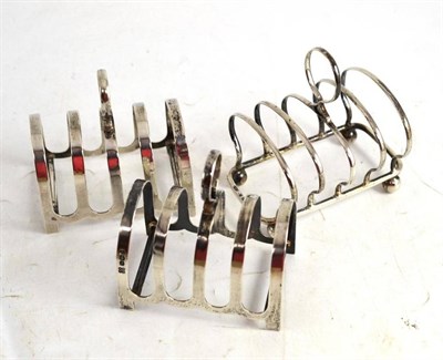 Lot 177 - Three silver toast racks