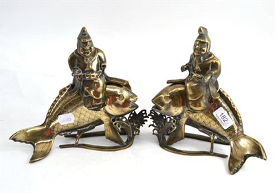 Lot 182 - Pair of Chinese metal figures of scholars seated on fish