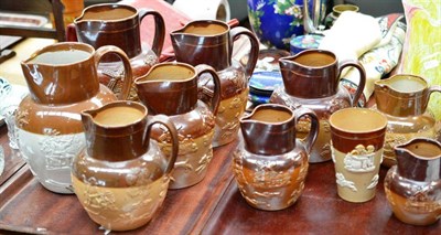 Lot 185 - A collection of nine assorted 19th and 20th century Stoneware jugs and a beaker decorated with...