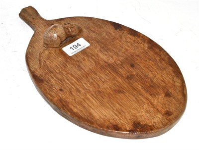 Lot 194 - A Robert ";Mouseman"; Thompson oak cheese board, with a large carved mouse signature on the...