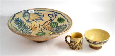 Lot 200 - A slipware pottery peacock bowl, a slipware milk jug and bowl (3)