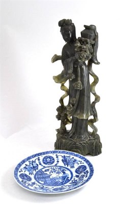 Lot 217 - A Chinese carved soapstone figure of Guanyin and a Chinese blue and white decorated plate