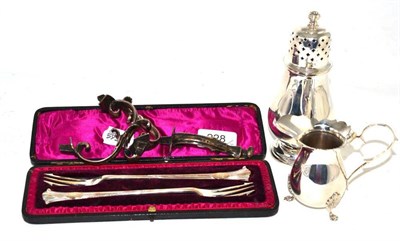 Lot 228 - A pair of pickle forks cased, a caster, cream jug, four scrolls