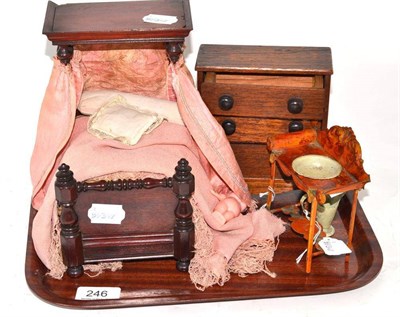 Lot 246 - A miniature mahogany bed, chest of drawers and tin plate washstand, jug and bowl