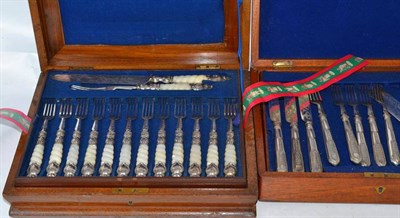 Lot 253 - A set of eighteen mother-of-pearl and plate dessert knives and forks, cased and a set of twelve...