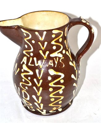 Lot 268 - Brown slipware jug decorated 'There'll always be an England'