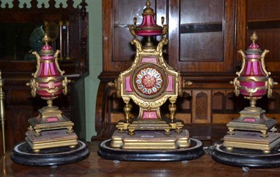 Lot 272 - A gilt metal and porcelain mounted striking mantel clock with garniture