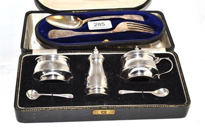 Lot 285 - A three piece silver cruet set, cased and a cased silver Christening set