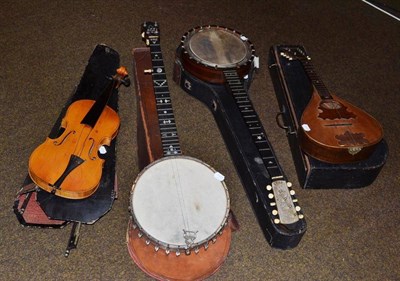 Lot 315 - Two banjos, violin and bow and a mandolin