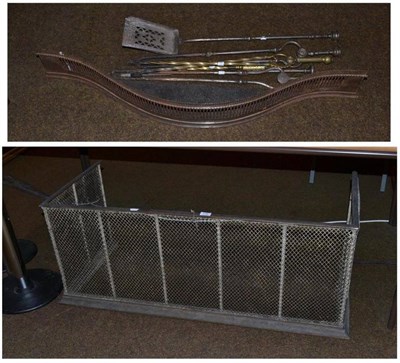 Lot 316 - A brass nursery fender, steel serpentine fender, four steel fire irons and two brass fire irons