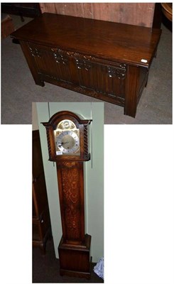 Lot 404 - A small chiming longcase clock and a carved small chest