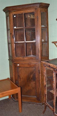 Lot 413 - A late 18th/early 19th century fruitwood floor standing corner cabinet with glazed upper section