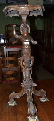 Lot 442 - Carved wooden tripod table with figurative column supports