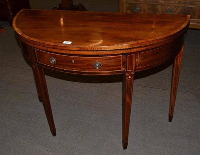 Lot 443 - George III fold-over mahogany and tulipwood banded table