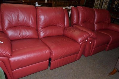 Lot 453 - A pair of AMX Design red leather two seater reclining sofas