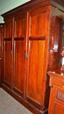 Lot 504 - An early 20th century mahogany three door wardrobe with oak linen drawers and hanging space