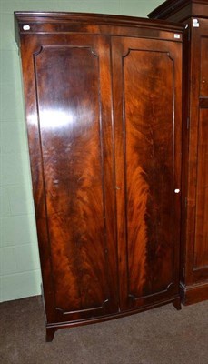 Lot 505 - A bow fronted mahogany wardrobe