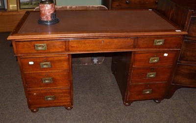 Lot 515 - Edwardian mahogany pedestal desk with campaign style handles