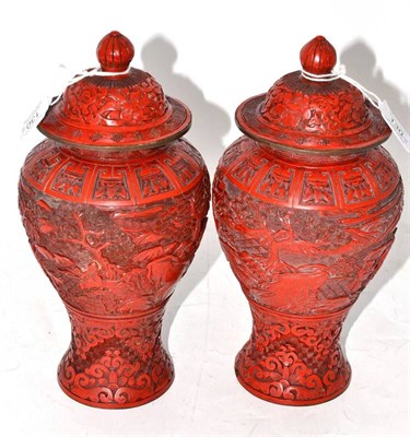 Lot 130 - A Pair of Chinese Cinnabar Lacquer Baluster Vases and Covers, 19th century, carved with a...