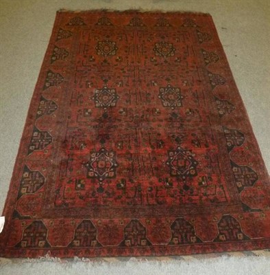 Lot 609 - Afghan rug, North West Afghanistan, the madder field with two columns of indigo medallions...