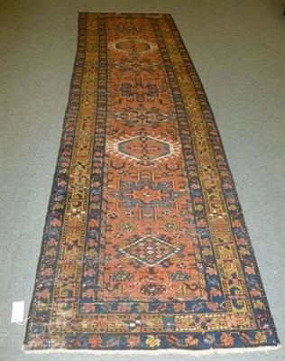 Lot 610 - Heriz runner, Persian Azerbaijan, the salmon pink field with a row of medallions framed by...