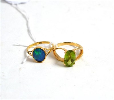 Lot 26 - A peridot ring stamped '18k' and an opal triplet ring stamped '18ct'