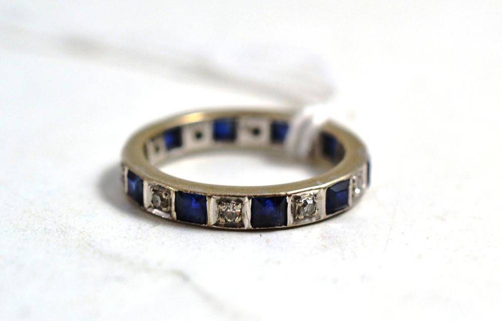 Lot 27 - A sapphire and diamond eternity ring, stamped '585'
