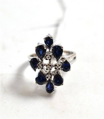 Lot 41 - A sapphire and diamond cluster ring, stamped '18k'