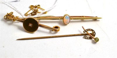 Lot 43 - A 15ct gold diamond brooch, an opal bar brooch stamped '15ct', a peridot and seed pearl stick pin